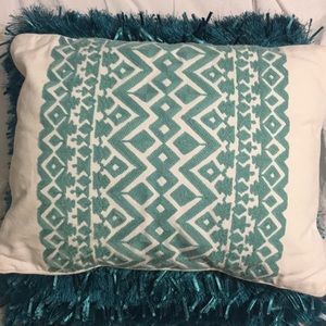 White and teal throw pillow